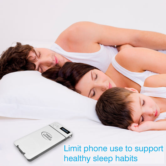 Family sleeping together with a phone control device on a white background